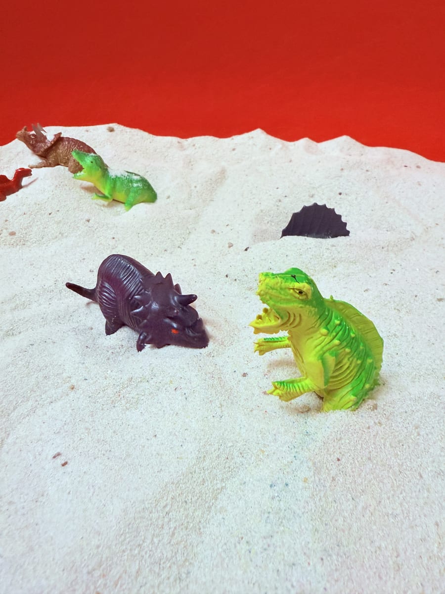 Sensory play — dinosaurs in the sand tray